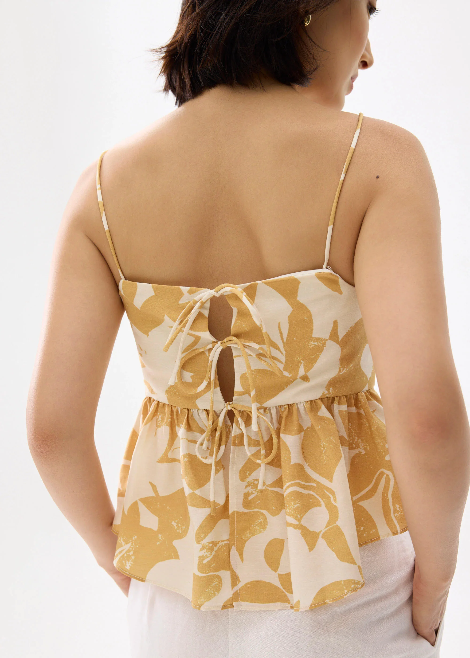 PADDED BABYDOLL PEPLUM TOP IN SUNBURST - GOLD