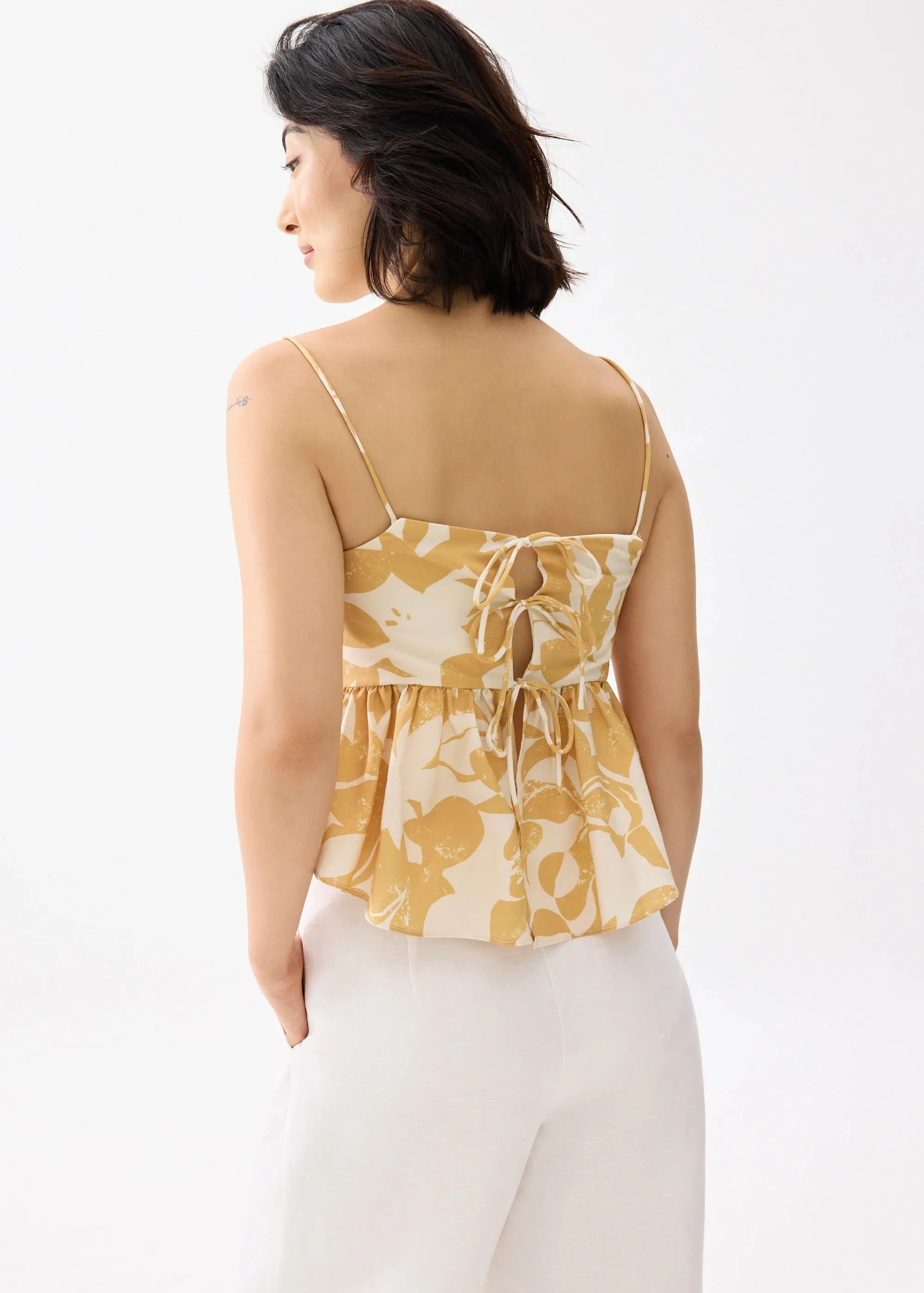 PADDED BABYDOLL PEPLUM TOP IN SUNBURST - GOLD